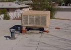 Evaporative cooler sitting on bricks